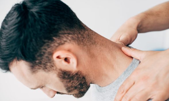 Cropped view of doctor massaging patient neck in massage cabinet at clinic