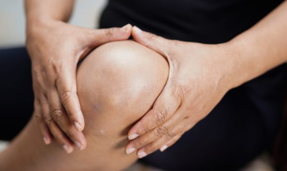 Asian middle-aged lady woman patient touch and feel pain her knee : healthy medical concept.