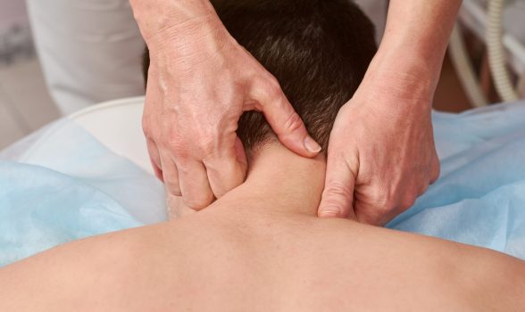 Neck massage close up. Female hands massaging neck. Releasing tight muscles.