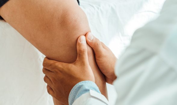 Physiotherapist treating with patient about elbow pain problems.Physical therapy concept